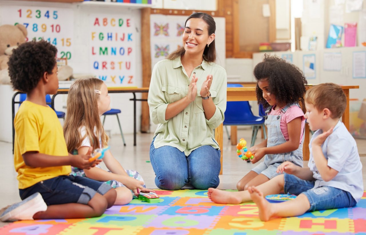 shot-of-a-teacher-singing-with-her-preschool-children.jpg